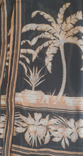 Load image into Gallery viewer, Close-up of a fabric with tropical palm tree and floral design on a dark background